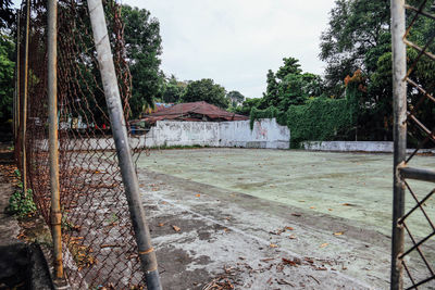 Weathered chainlink fence against abandoned soccer field