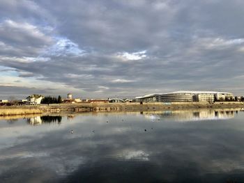 Reflection of building in lake against sky