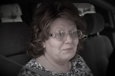 Close-up of woman sitting in car