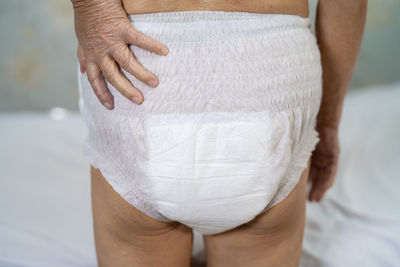 Midsection of woman standing at home