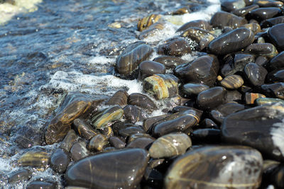High angle view crowd of polished stones on shore