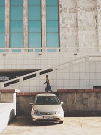 Man in car against building