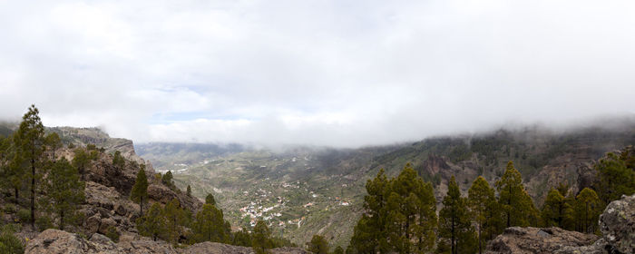 Scenic view of mountains against cloudy sky