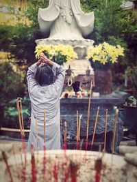 Rear view of woman standing against temple