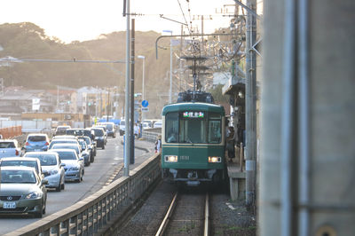 Railroad tracks in city against sky