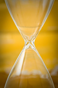 Close-up of glass falling on sand