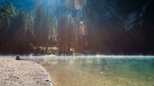 A man was sleeping near the braies lake. view of the braies lake at early morning. 