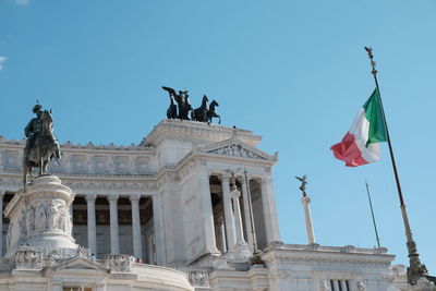 Low angle view of statues against sky