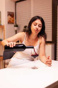 Young woman using mobile phone at home