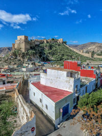 Buildings in town against blue sky