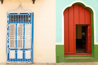 Red door in green wall, sancti spiritus - cuba