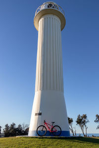 Low angle view of white tower against clear blue sky