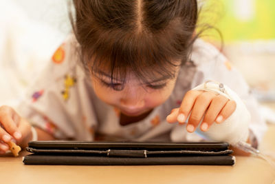 Girl using digital tablet at home