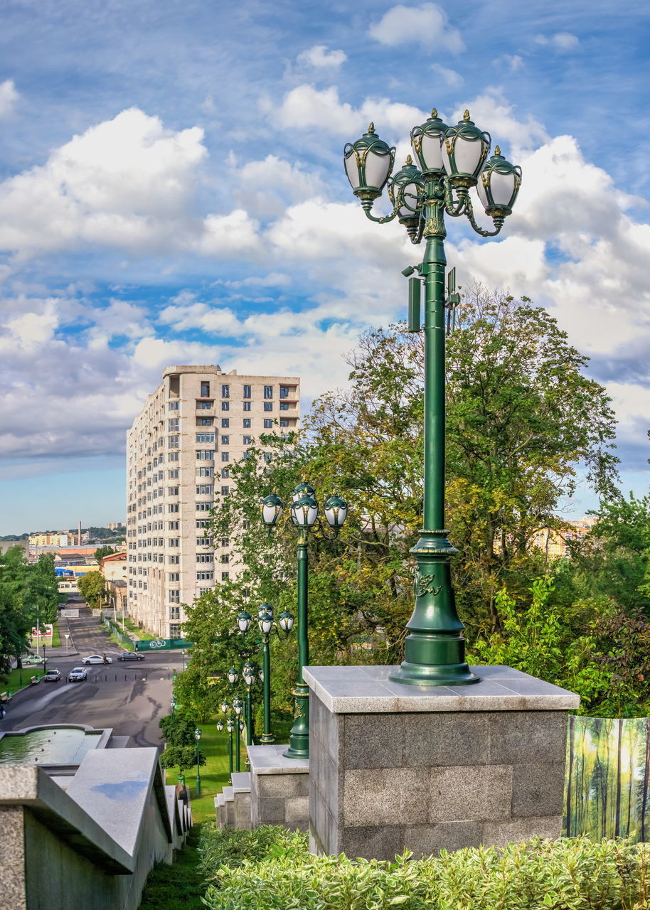 STREET LIGHT BY BUILDING AGAINST CLOUDY SKY