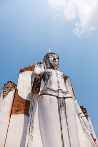 Low angle view of statue against blue sky