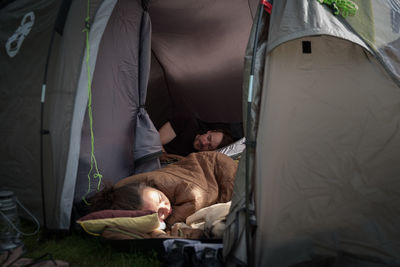 People sleeping with pug in tent