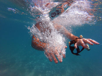 People swimming in sea, underwater