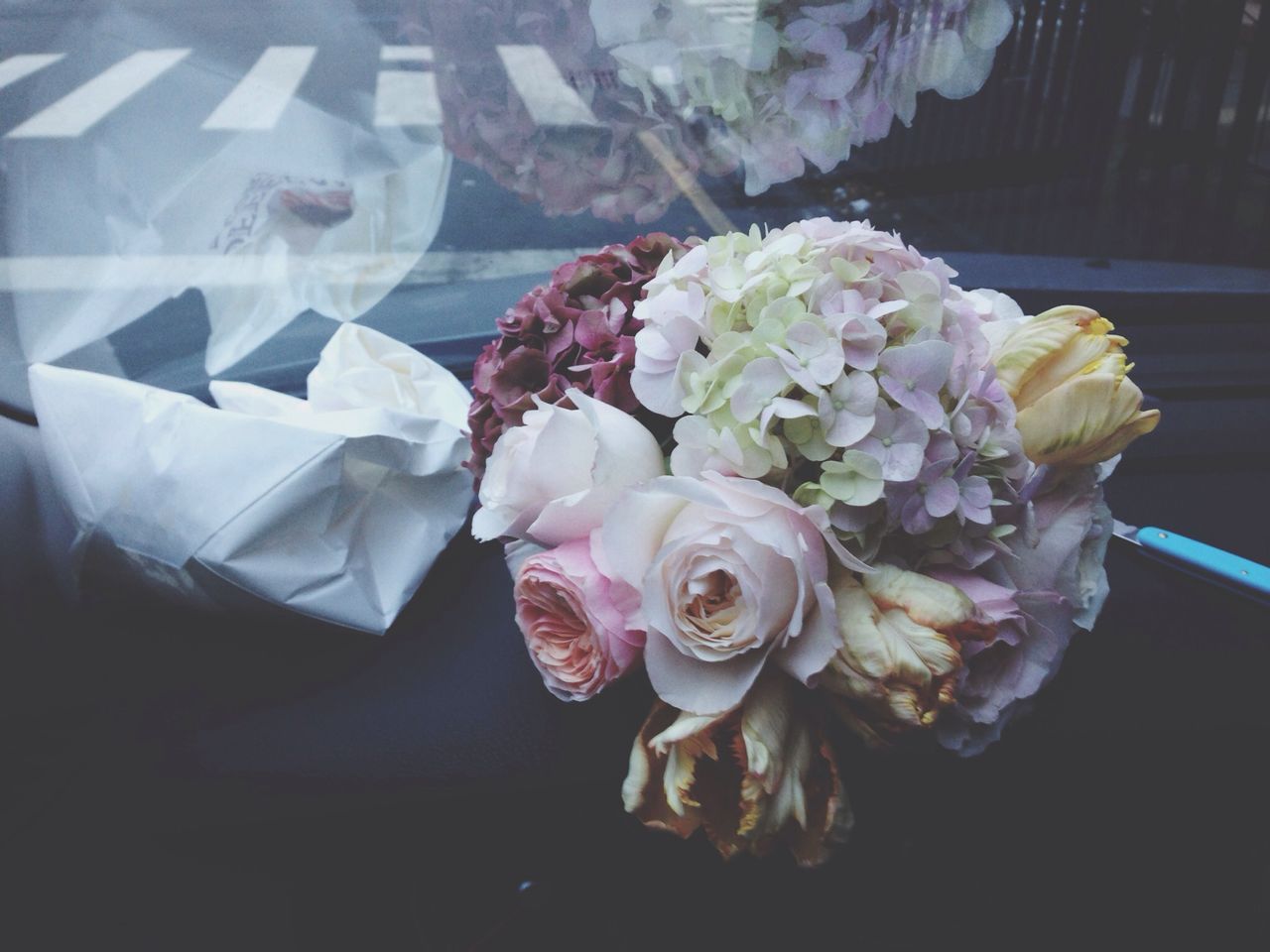 flower, petal, flower head, fragility, indoors, freshness, rose - flower, vase, close-up, beauty in nature, high angle view, growth, nature, blooming, white color, table, no people, plant, flower arrangement, bunch of flowers