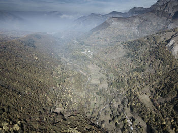 High angle view of land and mountains against sky