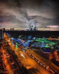 High angle view of illuminated cityscape against sky at night