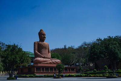 Statue against blue sky