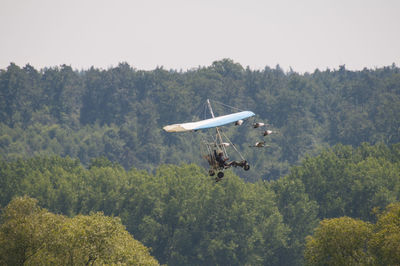 Air vehicle over trees in forest