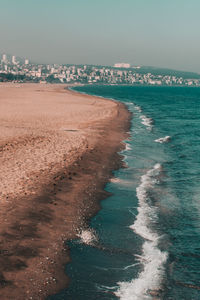 Scenic view of sea against sky in city