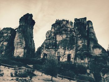 Low angle view of rock formations against sky