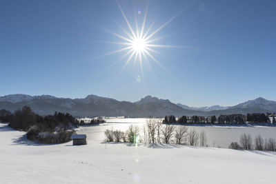 Scenic view of snowcapped mountains against blue sky