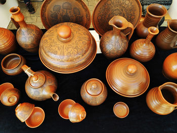 Beautiful brown different handmade tableware made of clay and porcelain on the table.