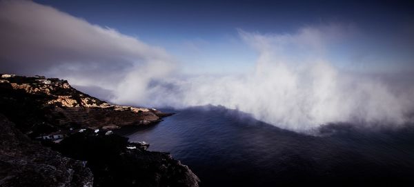 Scenic view of mountains against cloudy sky