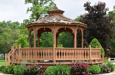 Built structure by trees against sky