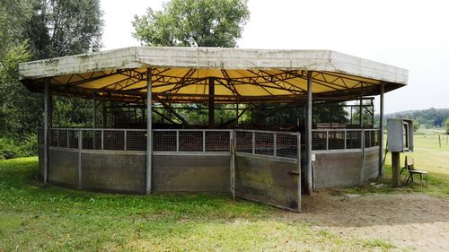 Built structure on field against sky