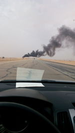 Close-up of car on road against sky