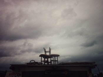 Low angle view of building against cloudy sky