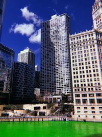 Low angle view of modern buildings in city against sky