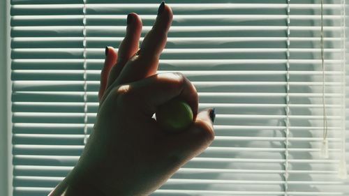 Close-up of hand holding window