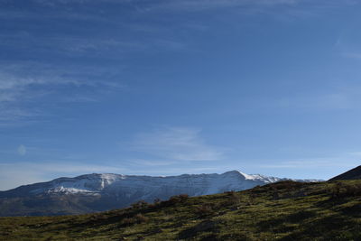 Scenic view of mountains against cloudy sky