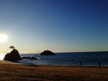 Scenic view of sea against clear sky during sunset