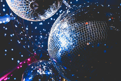 Disco balls reflect light at the party
