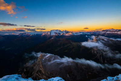 Scenic view of snow covered mountains during sunset