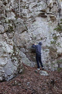 Rear view of man standing on rock