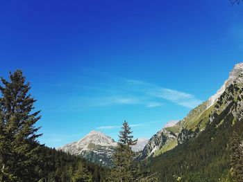 Scenic view of mountains against blue sky