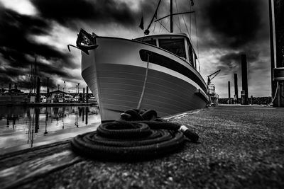 Sailboat on harbor against sky in city