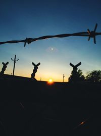 Low angle view of silhouette bird flying in sky