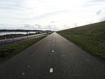 Empty road along landscape