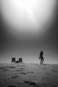 Man on beach against clear sky