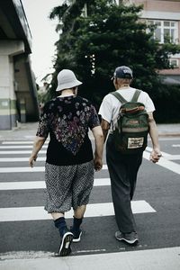 Rear view of people walking on street