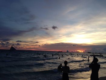 Silhouette of people on beach