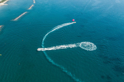 Aerial view of people jet boating in sea